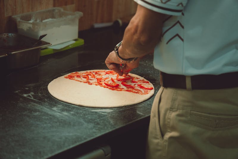 Giordanos kitchen team preparing fresh giordanos pizza with quality ingredients